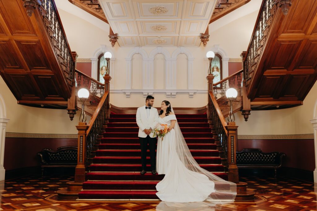 2023_C&P Church Wedding Ceremony_gallery grand staircase bride and groom